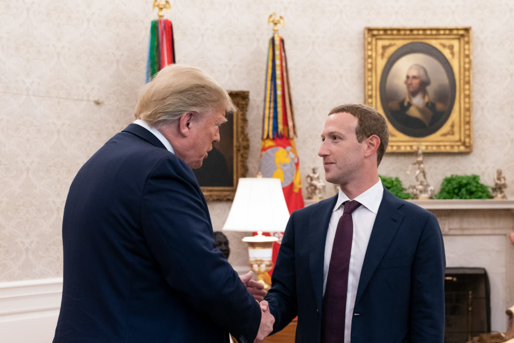 Donald Trump and Mark Zuckerberg shaking hands in the Oval Office.